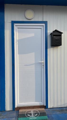 a white door with a sign in front of a building at Oh, Mon Bateau! No running water, bez tekuce vode in Belgrade