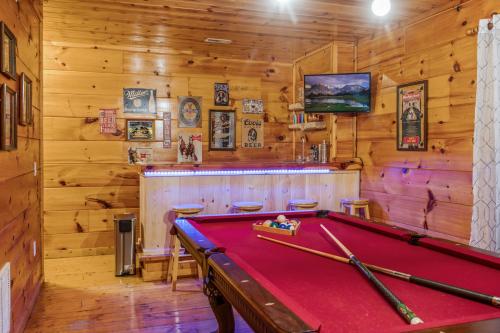 a pool table in a room with a bar at Bearadise-Private Cabin that Sleeps 8, with 3 Full Bathrooms, Pool Table, Board Games and Wet Bar in Sevierville