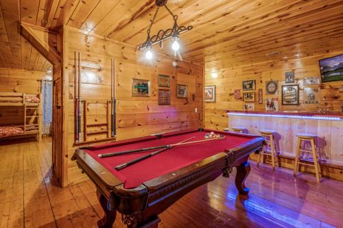 a pool table in a room in a cabin at Bearadise-Private Cabin that Sleeps 8, with 3 Full Bathrooms, Pool Table, Board Games and Wet Bar in Sevierville