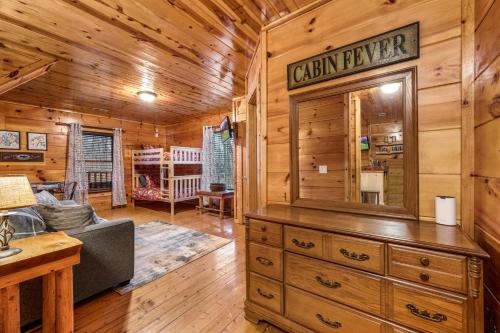 a log cabin living room with a large dresser at Bearadise-Private Cabin that Sleeps 8, with 3 Full Bathrooms, Pool Table, Board Games and Wet Bar in Sevierville
