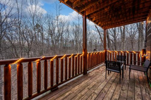 a porch of a cabin with a bench on it at Bearadise-Private Cabin that Sleeps 8, with 3 Full Bathrooms, Pool Table, Board Games and Wet Bar in Sevierville