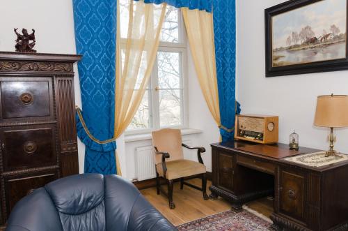 a room with a desk and a chair and a window at Ēdoles Pils in Ēdole