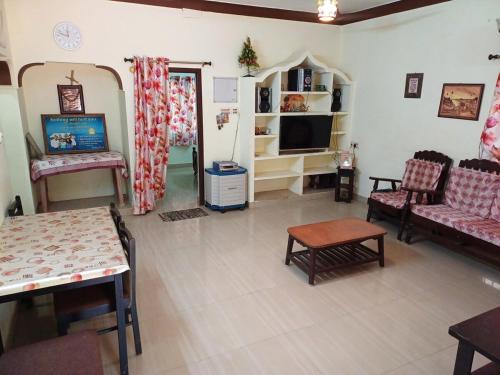 a living room with a couch and a tv at Brewvilla 'Solaris ' in Puducherry