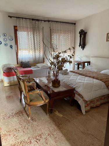 a bedroom with a bed and a table and chairs at #Punto FM 6# in Marghera