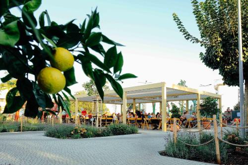 a pavilion with people sitting at tables in a restaurant at Luxusný Penthouse nad jazerami 230 m2, 2x garáž, WIFI in Senec