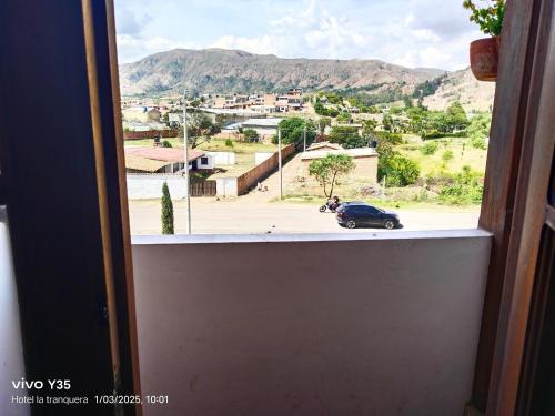 a window with a view of a car on a street at Hotel San Luis Sachica ng in Sáchica