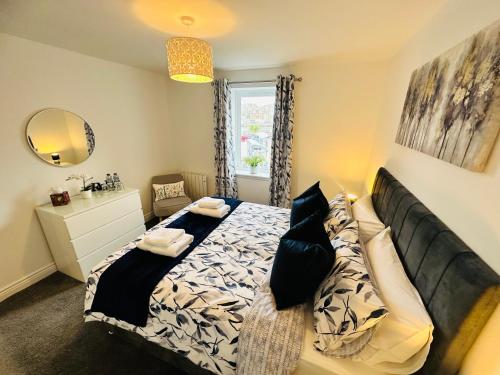 a bedroom with a bed and a mirror at Kilmartin Court Apartments - No3 By The Sea & No2 With A View - free parking in Oban
