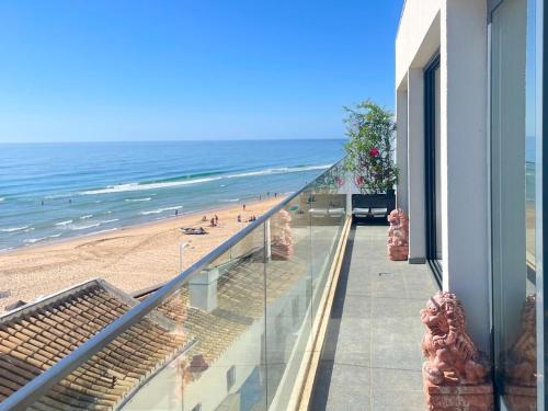 a balcony with a view of the beach from a building at Casa Dourada - Golden Beach Apt in Budens