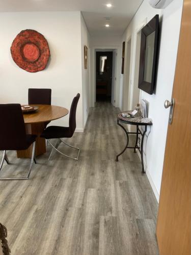 a hallway with a table and chairs and a dining room at Casa Dourada - Golden Beach Apt in Budens