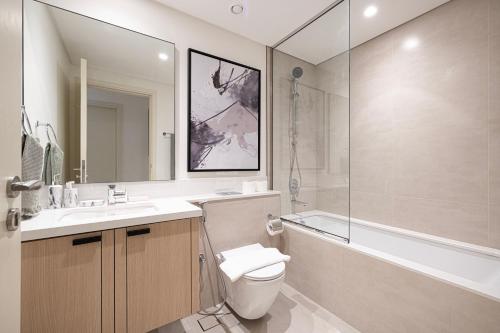 a bathroom with a toilet and a sink and a shower at DVH Luxe, Elegant 4BR Villa, Gated Resort Amenities, Ranches 3 in Dubai