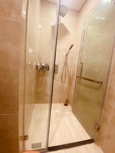 a shower with a glass door in a bathroom at 7Homestay in Hai Phong