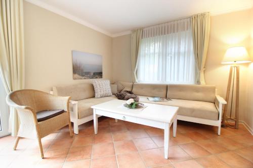 a living room with a couch and a table at Haus am Park Wohnung Nr4 in Spiekeroog