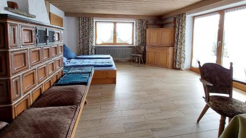 a room with two beds and a couch in it at Ferienwohnung Nr 1, Lechbruck-Gründl, Allgäu in Prem