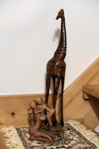 a wooden statue of a giraffe and some people at At Anna's house in the heart of Salento in Supersano