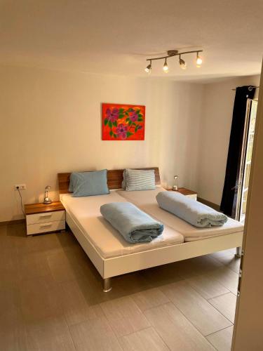a bedroom with a large white bed with two pillows at Ferienwohnung Mops in Nauders