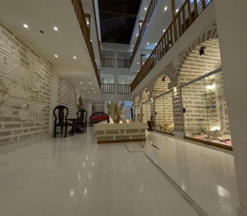 a large room with a store with white floors and ceilings at Hotel Kachi de Uyuni in Uyuni