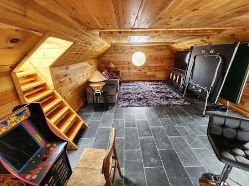 an attic room with a staircase in a cabin at the Sugar Cube, a stunning, spacious, and modern villa with an orchard maze in Ithaca