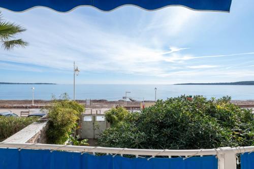 une vue sur la plage depuis le balcon d'un immeuble dans l'établissement 2-Br Seafront Apartment in Cannes, à Cannes