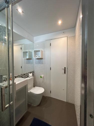 a bathroom with a toilet and a sink at Vila Mar in Porto Covo