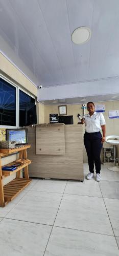 a man standing in an office holding a microphone at Edificio Regata INN in Buenaventura