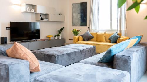 a living room with couches and a flat screen tv at San Carlo Premium - Torino Centro in Turin