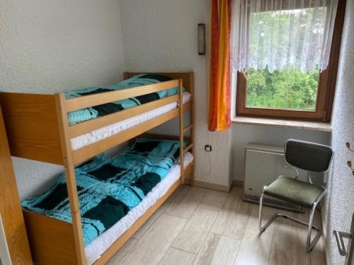 two bunk beds in a small room with a window at Appartment 016 in Tossens in Stick