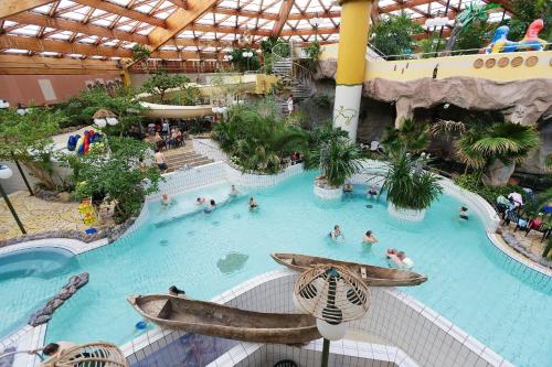 an indoor swimming pool with people in a resort at Appartment 016 in Tossens in Stick