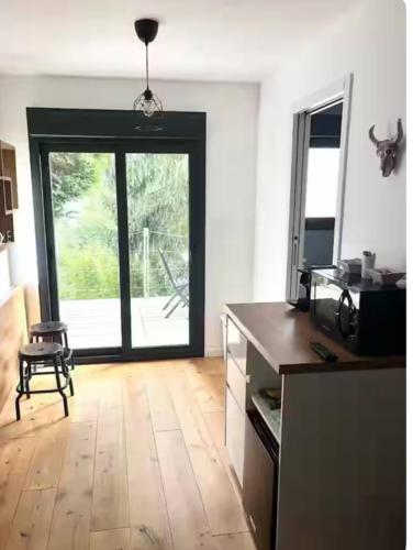 Il dispose d'une cuisine avec une grande porte en verre et du parquet. dans l'établissement Studio cosy indépendant Centre ville-Quartier facultés, à Nantes