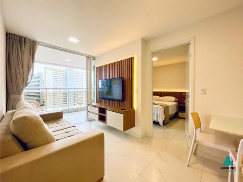 a living room with a couch and a television at Aquarius Style by Holiday Stays in Fortaleza