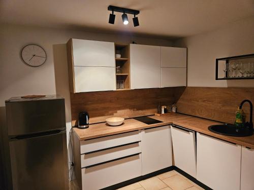 a kitchen with white cabinets and a refrigerator at Apartment Vuletic, Ždrelac Pašman in Ždrelac
