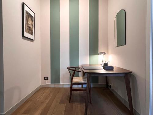 a table in a room with green and white stripes at San Carlo Premium - Torino Centro in Turin