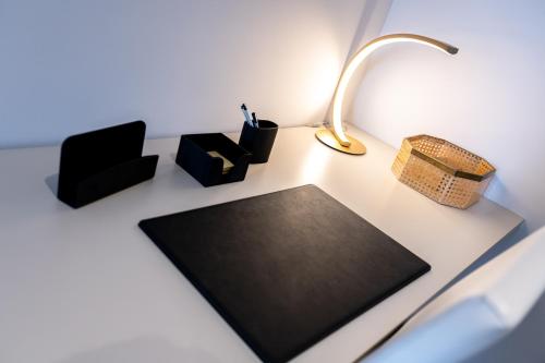 a desk with a lamp and other items on it at San Carlo Premium - Torino Centro in Turin