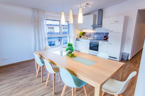 a kitchen and dining room with a wooden table and chairs at City Dream 1 by Alpenidyll Apartments in Schladming