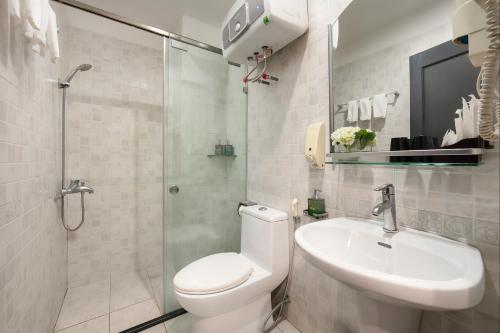 a bathroom with a toilet and a sink and a shower at La Palm Boutique Hotel in Hanoi
