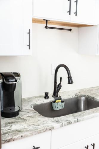 a kitchen counter with a sink and a toaster at Latitude Adjustment in Virginia Beach