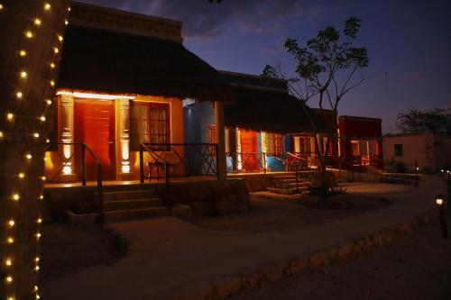 a house lit up at night with lights at Hotel Aldea Katún in Izamal