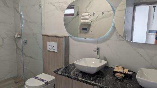 a bathroom with a sink and a mirror at Hotel Boutique Mitad Del Mundo in Quito