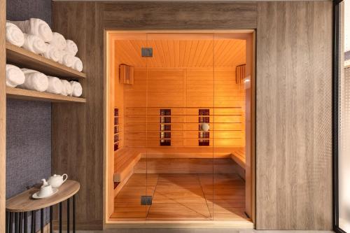 a sauna with a glass door in a room at Mercure Sofia City in Sofia