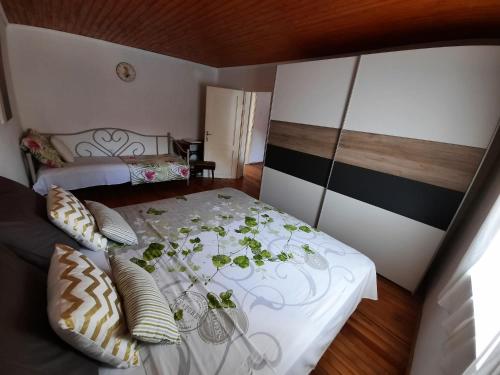 a bedroom with a white bed with plants on it at RELAXED PLACE by the sea in Cesarica