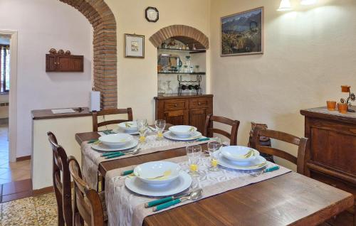 a dining room with a table with plates and glasses at Cozy Apartment In Montenero D'orcia in Montenero