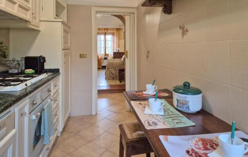 a kitchen with a table and a counter top at Cozy Apartment In Montenero D'orcia in Montenero