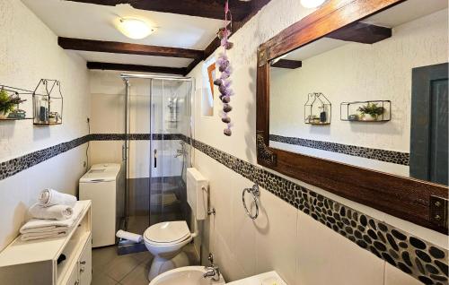 a bathroom with a shower and a toilet and a sink at 2 Bedroom Cozy Home In Lovran in Lovran