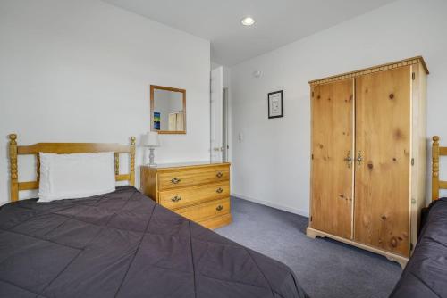 a bedroom with a bed and a wooden dresser at Assateague Overlook - Water views w/ public dock! in Black Point Landing