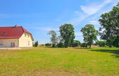 a house with a red roof in a field at Ferienwohnung Dabel in Dabel