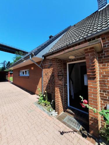 a brick house with a large window on it at Ferienhaus in der Schleife 2 in Rendsburg in Rendsburg