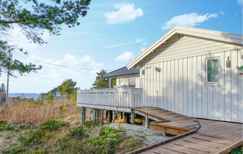 a house with a wooden deck next to a building at 2 Bedroom Amazing Home In Agdenes in Fremstad