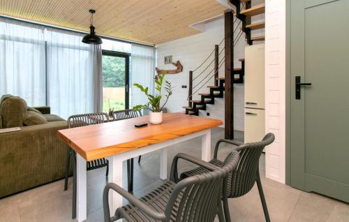 a living room with a wooden table and chairs at Beautiful Home In Potolowek With Sauna in Potołówek
