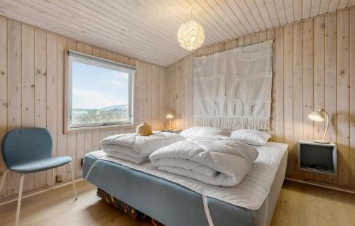a bedroom with a bed with white pillows and a window at Stunning Home In Ebeltoft With Wifi in Ebeltoft