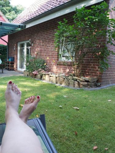 a person with their feet up in the grass at Hümmling HA16 in Sögel