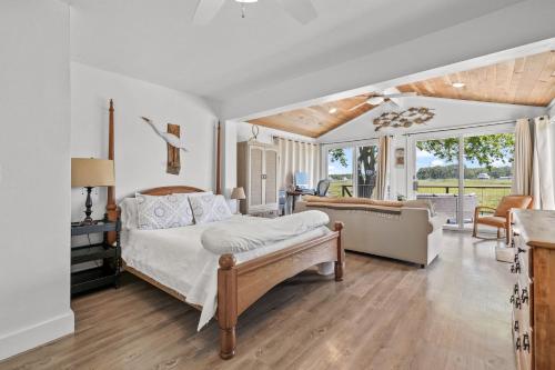a bedroom with a bed and a living room at Beach Bungalow - Pet friendly cottage w/ Amazing views! in Deep Hole